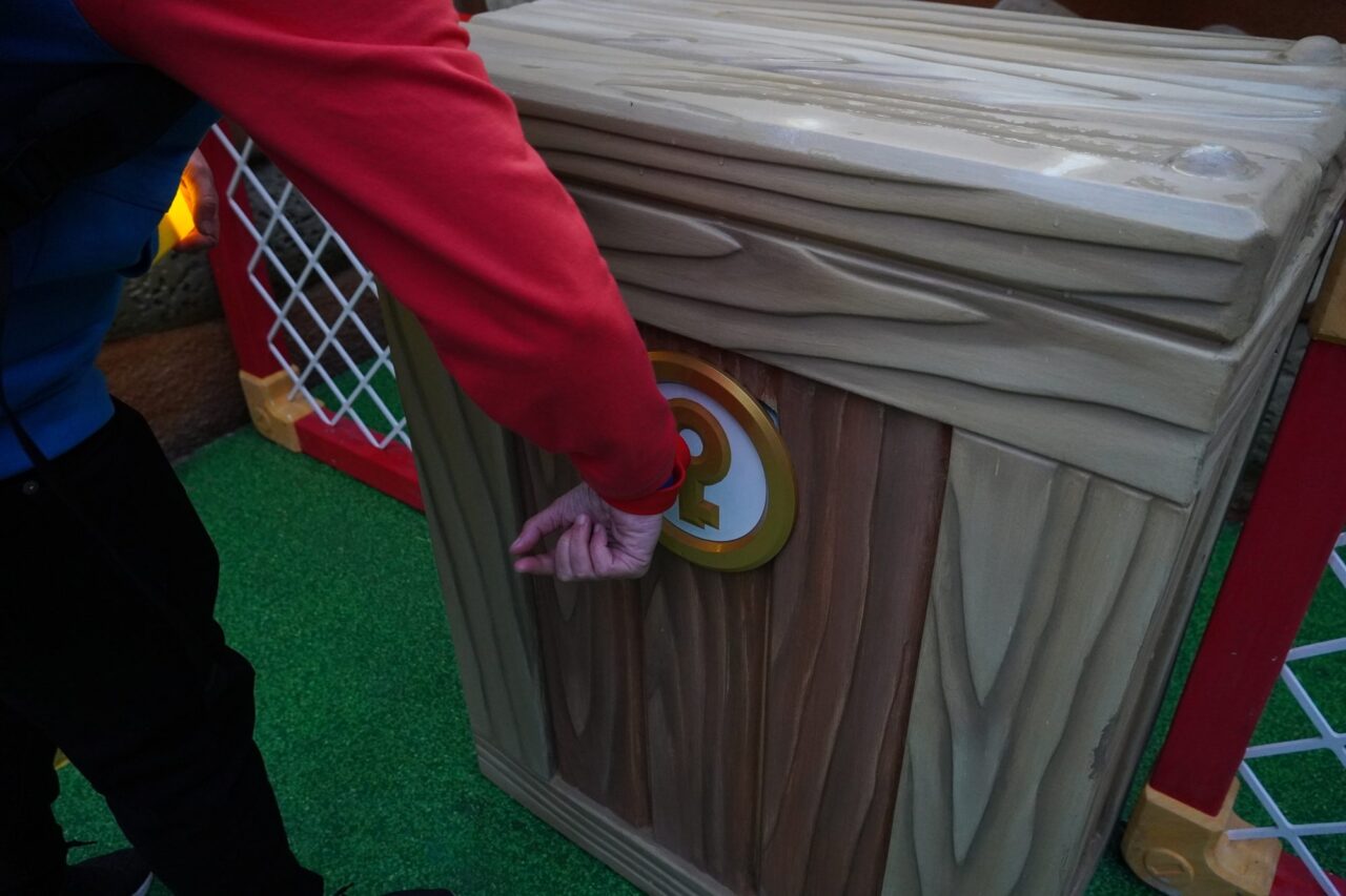 Tapping a Power-Up Band on a key block to start a Super Nintendo World mini game