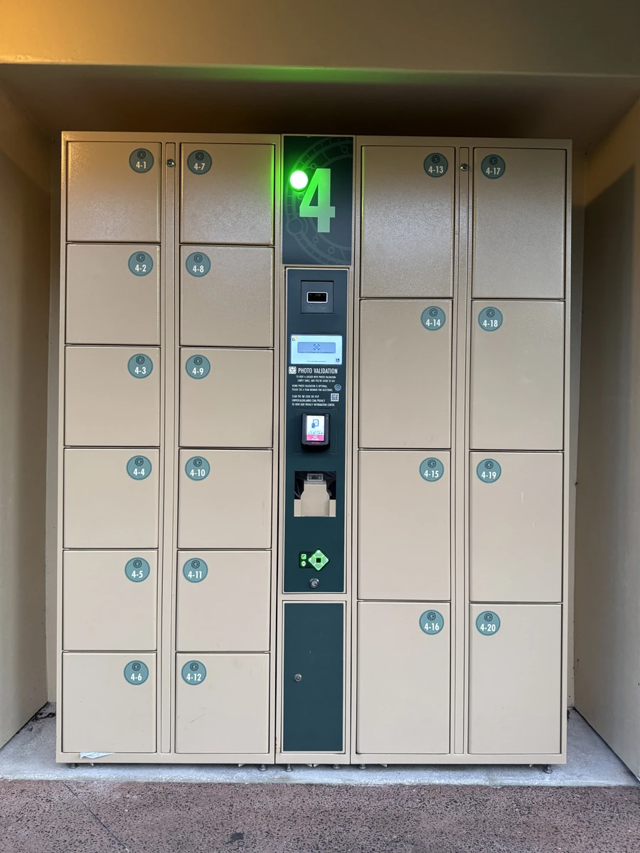 Photo Validation free attraction locker bank at Epic Universe, Universal Orlando Resort, with the green availability light