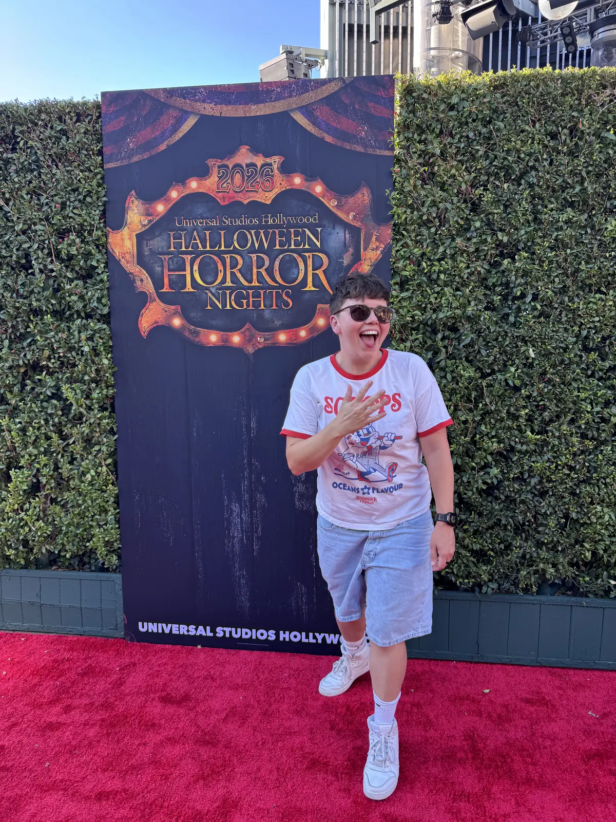 Cora on the red carpet in front of the Halloween Horror Nights backdrop on opening night at Universal Studios Hollywood