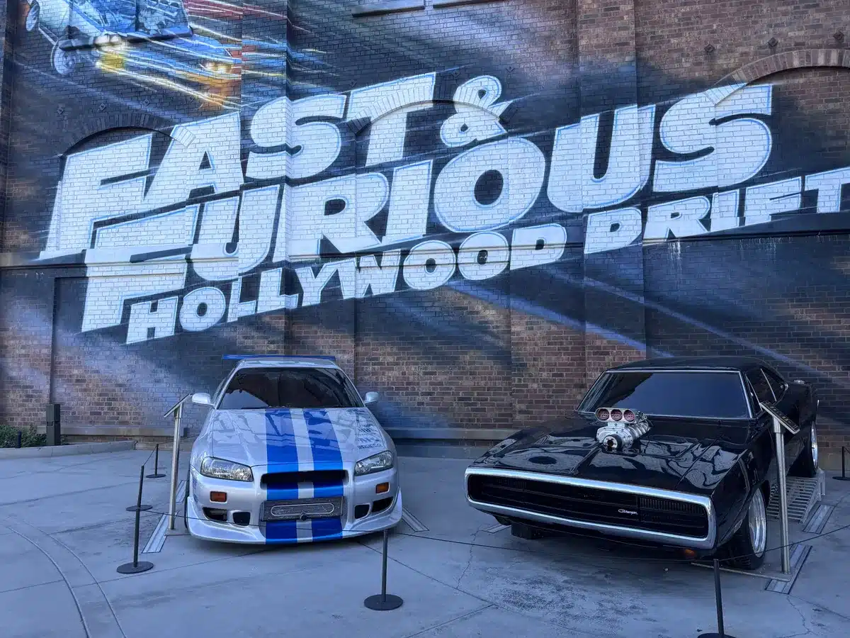 Two Fast & Furious cars parked outside the Hollywood Drift entrance at Universal Studios Hollywood