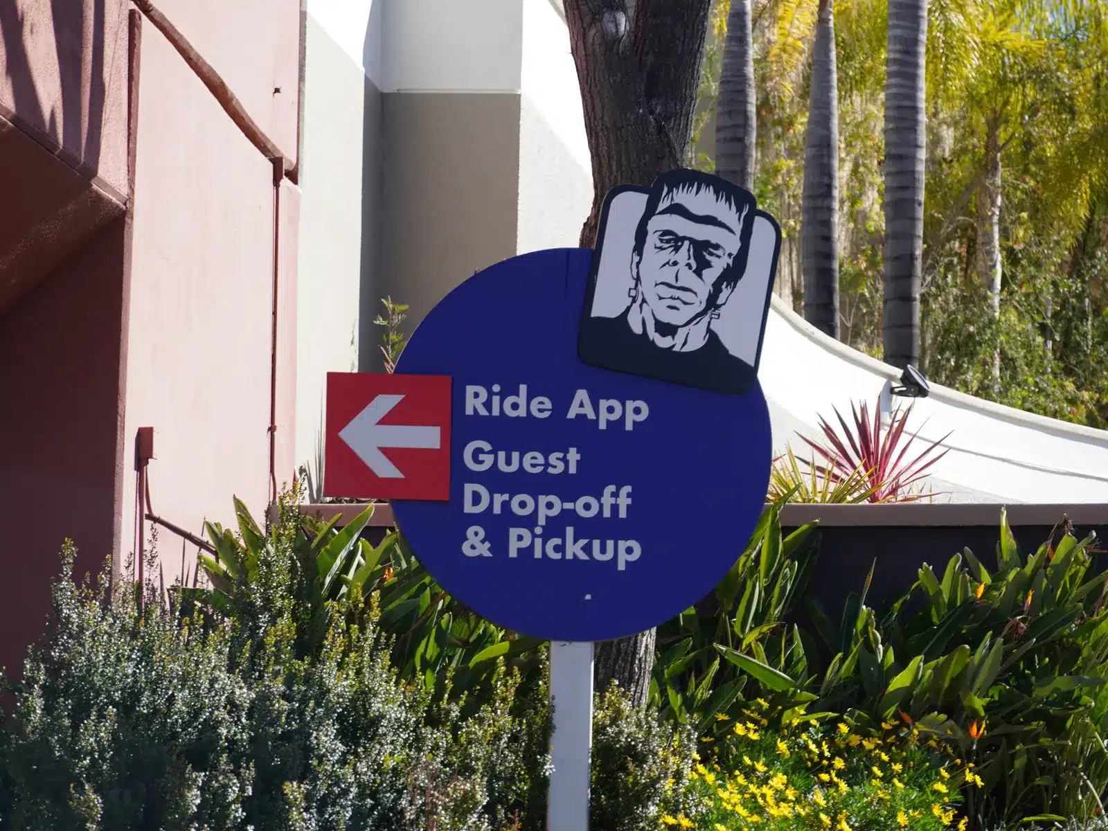 Ride app guest drop-off and pick-up sign with the Frankenstein logo at Universal Studios Hollywood